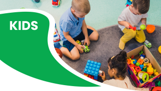 Children playing with colorful toys beside a green and white design with the word "KIDS."