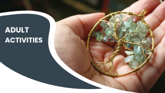 A hand holding a tree-shaped pendant with pale green stones, next to the words "ADULT ACTIVITIES."
