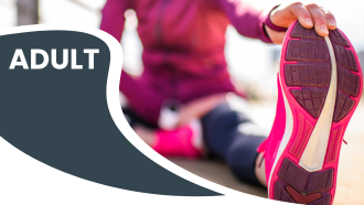 Person stretching outdoors in pink athletic wear with focus on sole of bright pink shoe, labeled "ADULT."