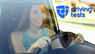 Person smiling while sitting in a car with "driving tests" text and logo in the corner.
