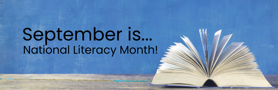 An open book with fanned-out pages on a wooden surface, against a blue background with text stating, "September is... National Literacy Month!"