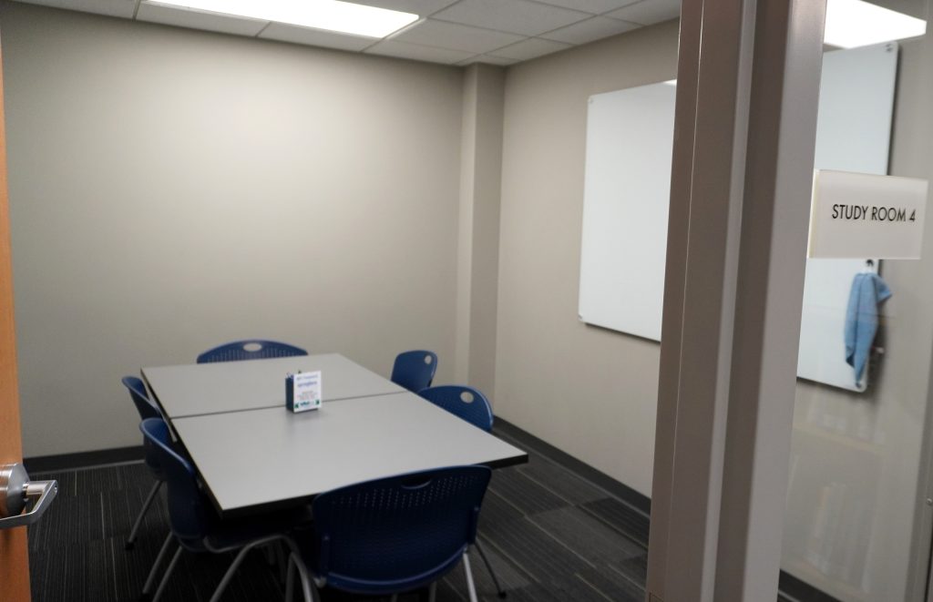 Interior of study room with table, six chairs, and whiteboard with "STUDY ROOM 4" text.